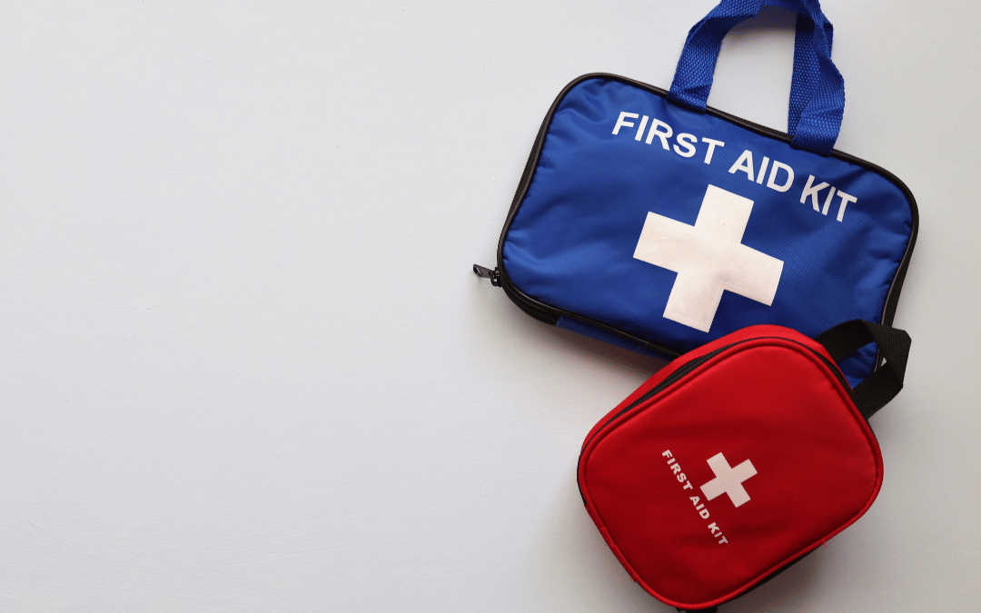 Two first aid kits, one blue and one red, side by side, symbolizing preparedness for emergencies.