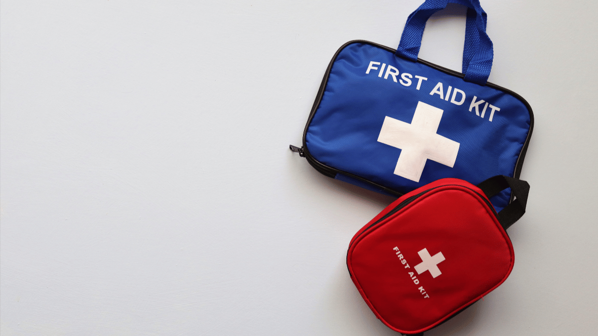 Two first aid kits, one blue and one red, side by side, symbolizing preparedness for emergencies.