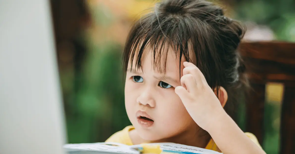 A young child looking confused, representing the decision-making process of choosing between online and in-person CPR and First Aid certification.