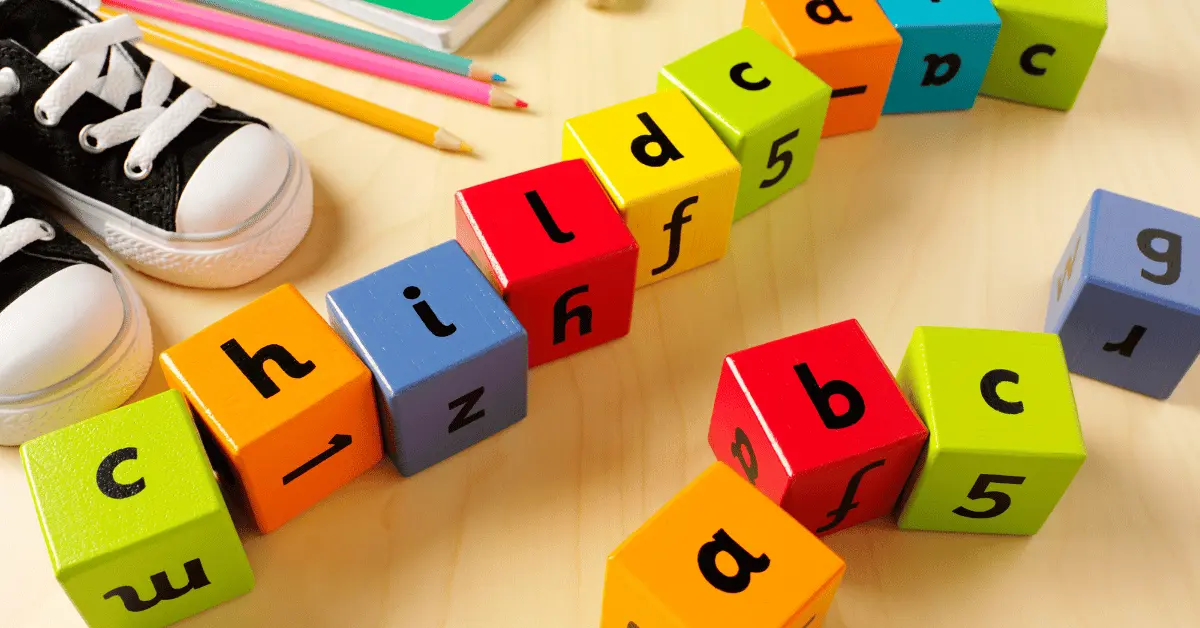Colorful wooden blocks and children’s items arranged to spell “Childcare ABCs,” representing early childhood education and safety training.